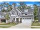 Charming two-story home with gray siding, stone accents, and a well-manicured lawn at 9164 Dupree Meadow Dr # 14, Angier, NC 27501