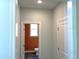 Hallway leading to a powder room featuring an orange accent wall and modern fixtures at 9164 Dupree Meadow Dr # 14, Angier, NC 27501