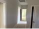 Hallway with neutral paint, white trim, and doors leading to rooms at 9164 Dupree Meadow Dr # 14, Angier, NC 27501