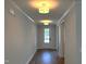 Inviting hallway with hardwood floors, recessed lighting, and neutral walls leading to a white front door at 9164 Dupree Meadow Dr # 14, Angier, NC 27501