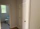 Hallway with a view into the half-bathroom and a white door to what appears to be a closet at 9164 Dupree Meadow Dr # 14, Angier, NC 27501
