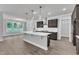 Modern kitchen with island, pendant lights, stainless hood, and wood-look flooring at 9164 Dupree Meadow Dr # 14, Angier, NC 27501