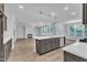 Open concept kitchen with island, stainless appliances, and view of living room with fireplace at 9164 Dupree Meadow Dr # 14, Angier, NC 27501