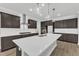 Modern kitchen with stainless steel appliances, large island, quartz countertops, and dark wood cabinetry at 9164 Dupree Meadow Dr # 14, Angier, NC 27501