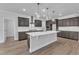 Stylish kitchen features a center island, pendant lighting, and stainless appliances at 9164 Dupree Meadow Dr # 14, Angier, NC 27501