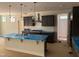 A kitchen with a central island, dark cabinets, and stainless steel appliances under protective covering at 9164 Dupree Meadow Dr # 14, Angier, NC 27501