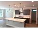 Spacious kitchen with an island, dark cabinets, white countertops, and stainless steel appliances at 9164 Dupree Meadow Dr # 14, Angier, NC 27501