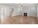 Open-concept living room with fireplace, wood floors, neutral walls, and lots of natural light at 9164 Dupree Meadow Dr # 14, Angier, NC 27501