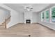 Bright living room features fireplace, wood-look flooring, and large windows at 9164 Dupree Meadow Dr # 14, Angier, NC 27501