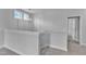 Stairwell with neutral walls, plush carpeting, white handrail and modern light fixture at 9164 Dupree Meadow Dr # 14, Angier, NC 27501