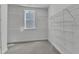 Spacious walk-in closet featuring wall-mounted shelving and a window for ample natural light at 9164 Dupree Meadow Dr # 14, Angier, NC 27501