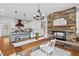 Spacious kitchen featuring stone fireplace, island, and stainless steel appliances at 9586 Tiara Farm Dr, Graham, NC 27253