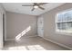 Bright bedroom featuring neutral walls, wood flooring, and exterior access at 102 Ingle Dr, Louisburg, NC 27549