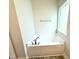 Bright bathroom featuring a white soaking tub with a view from a nearby window at 111 Southern Estates Dr, Sanford, NC 27330