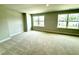 Spacious bedroom with plush carpet, and two large windows for natural lighting at 111 Southern Estates Dr, Sanford, NC 27330