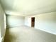 Bedroom featuring neutral walls, plush carpet, and a door leading to another room at 111 Southern Estates Dr, Sanford, NC 27330