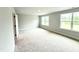 Bright bedroom with neutral carpet and paint boasts natural light from two windows at 111 Southern Estates Dr, Sanford, NC 27330