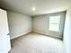 Bedroom with neutral carpet, one window, and fresh paint at 111 Southern Estates Dr, Sanford, NC 27330