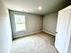 Bedroom with neutral carpet, one window, and fresh paint at 111 Southern Estates Dr, Sanford, NC 27330