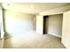 Bedroom with neutral walls and carpet featuring a closet with white doors and wire shelving at 111 Southern Estates Dr, Sanford, NC 27330