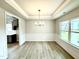 Dining room features recessed lights, paneled walls, hardwood floors, and a large window with natural light at 111 Southern Estates Dr, Sanford, NC 27330