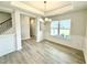Dining area featuring gray plank floors, modern chandelier and natural light at 111 Southern Estates Dr, Sanford, NC 27330