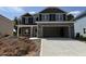 New two-story home with stone facade and two car garage on a sunny day at 111 Southern Estates Dr, Sanford, NC 27330