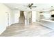 Open living room with kitchen view featuring a stairway and plank flooring at 111 Southern Estates Dr, Sanford, NC 27330