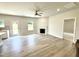 Open living room with fireplace, ceiling fan, and light wood floors at 111 Southern Estates Dr, Sanford, NC 27330