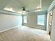 Spacious primary bedroom with tray ceilings, carpet flooring, and recessed lighting at 111 Southern Estates Dr, Sanford, NC 27330