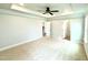 Spacious bedroom featuring tray ceilings, carpet floors, ceiling fan, and neutral paint at 111 Southern Estates Dr, Sanford, NC 27330