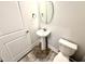 Cozy powder room with pedestal sink, decorative mirror, wood-look flooring, and modern fixtures at 111 Southern Estates Dr, Sanford, NC 27330