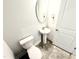 Powder room with a pedestal sink and oval mirror at 111 Southern Estates Dr, Sanford, NC 27330