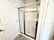 Modern glass walk-in shower featuring a seat, subway tile, and decorative accent tiles at 111 Southern Estates Dr, Sanford, NC 27330