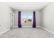 Bright bedroom with a large window offering a view and purple curtains at 1179 Cottonsprings Dr, Wendell, NC 27591