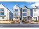 Three-story townhouses with gray siding, modern design, and landscaping at 1179 Cottonsprings Dr, Wendell, NC 27591