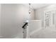 Upstairs hallway with a modern light fixture and carpet flooring at 1179 Cottonsprings Dr, Wendell, NC 27591