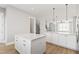 Kitchen island with granite countertop and white cabinets at 1179 Cottonsprings Dr, Wendell, NC 27591