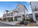 Townhouse rear view, showcasing deck, garage, and basketball hoop at 1179 Cottonsprings Dr, Wendell, NC 27591