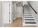 Modern staircase with dark wood and white risers at 1179 Cottonsprings Dr, Wendell, NC 27591