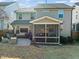 Home's back elevation showcasing a screened porch and patio at 1624 Drift Falls Ln Ln, Wendell, NC 27591