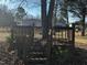 View of a rustic back deck and outdoor area with mature trees and natural foliage, providing an inviting space to relax at 165 Wakeline Dr, Wendell, NC 27591