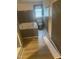 Bathroom with vinyl flooring and a tiled tub, offering a modern and functional space at 165 Wakeline Dr, Wendell, NC 27591