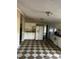 A kitchen boasts checkerboard flooring, white cabinets, and appliances, bathed in natural light at 165 Wakeline Dr, Wendell, NC 27591