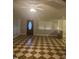 An open living room features checkerboard flooring, a ceiling fan, and a front door with decorative glass at 165 Wakeline Dr, Wendell, NC 27591