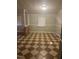 A spacious living room features checkerboard tile flooring, neutral walls, and large column features at 165 Wakeline Dr, Wendell, NC 27591