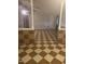 A partially open living room is showcased with checkerboard floors and pillar style dividers at 165 Wakeline Dr, Wendell, NC 27591