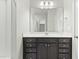 Bathroom with dark brown vanity, large mirror, and shower at 1819 Capstone Dr, Durham, NC 27713