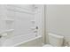 White bathroom with a bathtub, shower, and toilet at 1819 Capstone Dr, Durham, NC 27713