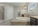 Bathroom with large garden tub and double vanity at 1819 Capstone Dr, Durham, NC 27713